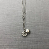 Meaning The tiniest locket, inscribed with the word "Be". To be; to inhabit or embrace a state of being. Invoke being at peace with yourself. Truly know, love, and accept your perfectly imperfect, delightfully authentic self. “To be yourself in a world that is constantly trying to make you something else is the greatest accomplishment.” ~ Ralph Waldo Emerson Details Locket measures approximately 1/4" in diameter. Hangs on a round cable chain Fastens with a lobster clasp