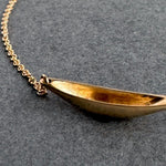 Gold necklace on a dark gray background