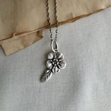 Forget Me Not Flower Charm, Sterling Silver on cream background