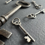 Collection of vintage keys on a dark surface