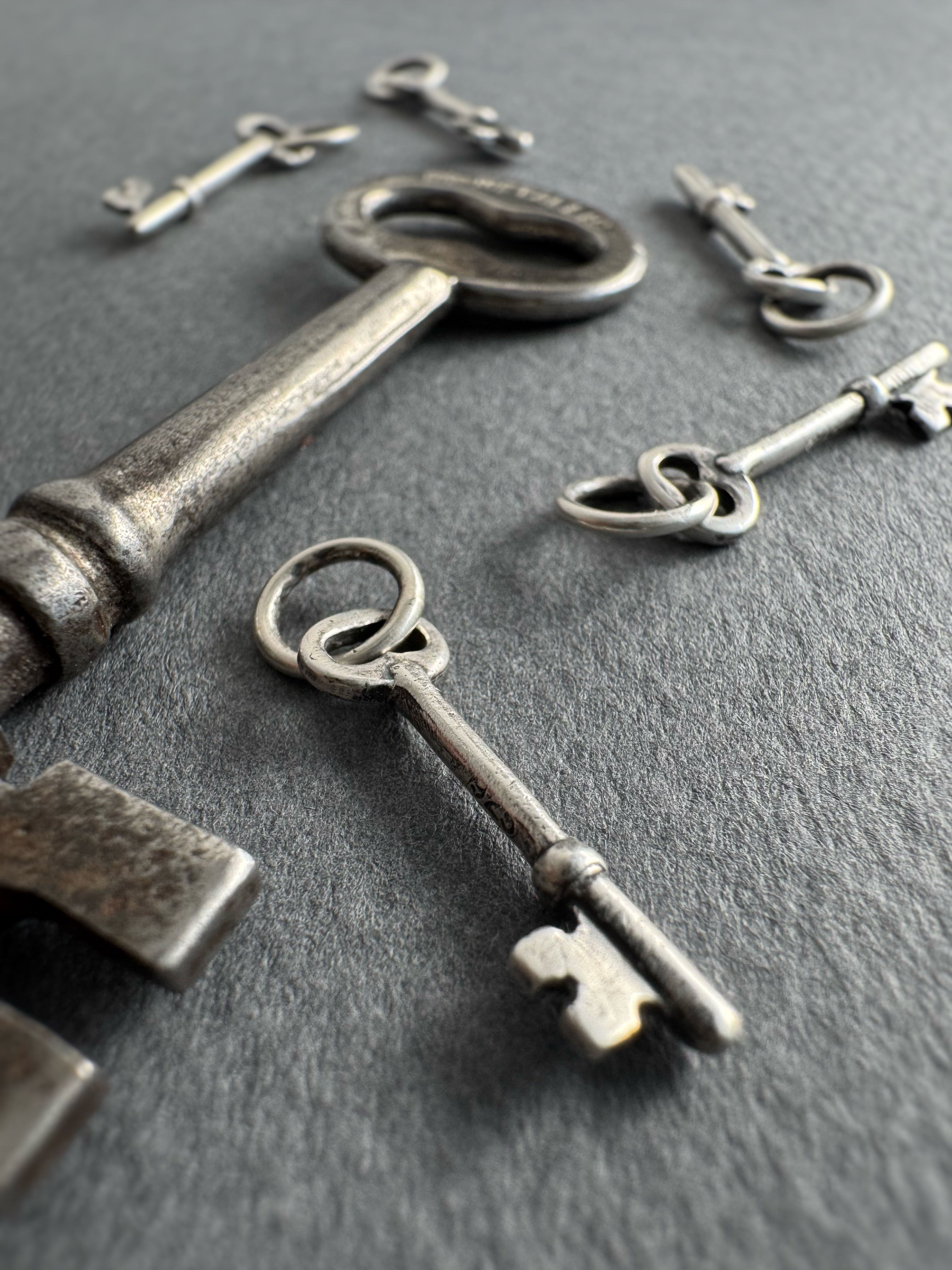 Collection of vintage keys on a dark surface