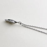 Sterling silver charm necklace, bird is in flight on cream background