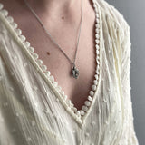 sterling silver sparrow necklace worn on model with white dress